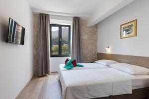 Postel nebo postele na pokoji v ubytování Hotel Vimbula - Komolac