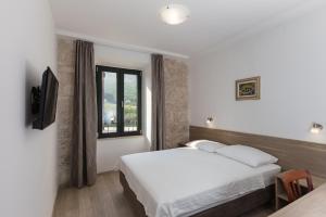 Postel nebo postele na pokoji v ubytování Hotel Vimbula - Komolac