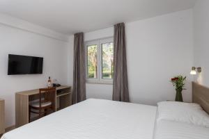 Postel nebo postele na pokoji v ubytování Hotel Vimbula - Komolac