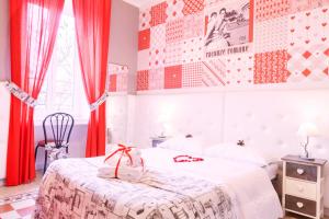 a bedroom with a bed with red curtains and a window at I Love Piramide in Rome