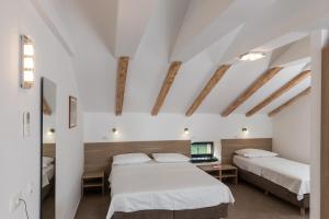 Postel nebo postele na pokoji v ubytování Hotel Vimbula - Komolac