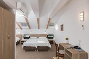 Postel nebo postele na pokoji v ubytování Hotel Vimbula - Komolac
