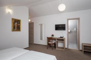 Postel nebo postele na pokoji v ubytování Hotel Vimbula - Komolac