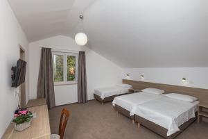 Postel nebo postele na pokoji v ubytování Hotel Vimbula - Komolac