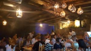 a group of people sitting at tables in a restaurant at L&A Villa Prainha 3 Bedrooms Heated Pool 5 m walking to the beach in Alvor +83 photos