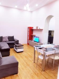 a living room with a couch and a table and chairs at Keti's Apartament Centre of Old Tbilisi in Tbilisi City
