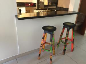 two colorful bar stools in front of a counter at Madre Natura in Asuncion