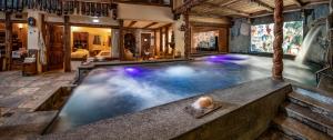 an indoor swimming pool in a house at Bellevue Hotel & SPA in Cogne