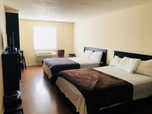 Ένα ή περισσότερα κρεβάτια σε δωμάτιο στο Langham Motel