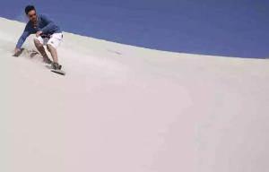 a man on a snowboard on a snow covered slope at Hostal Sisabel in Tinogasta
