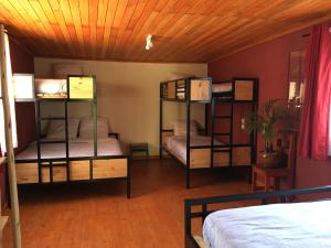 
a bedroom with a bed and a desk at SOUIMANGA-HOTEL in Antsirabe
