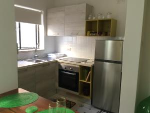 a kitchen with a stainless steel refrigerator and a table at L-Isla-Valletta-Cospicua in Senglea