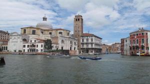 a group of buildings on a river with boats at Abitazione Morosini Apartment in Venice