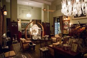 a living room filled with furniture and a chandelier at The Ajit Bhawan - A Palace Resort in Jodhpur