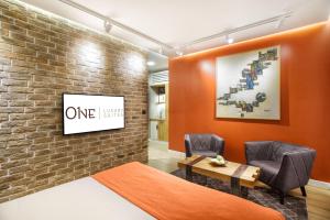 a room with a one sign on a brick wall at One Luxury Suites in Belgrade