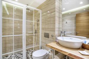 a bathroom with a toilet and a sink and a shower at One Luxury Suites in Belgrade