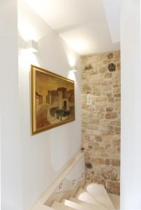 a bathroom with a painting on the wall at Vila Magdalena in Supetar +56 photos