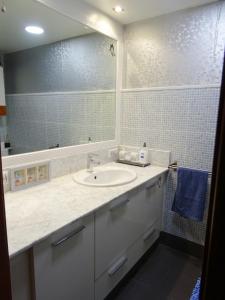 a bathroom with a sink and a mirror at Centro y playa in A Coruña