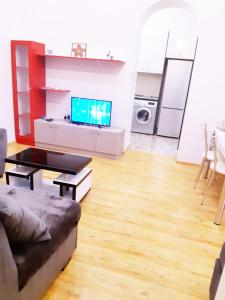 a living room with a couch and a tv at Keti's Apartament Centre of Old Tbilisi in Tbilisi City