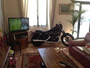 a living room with a motorcycle parked in it at Hotel Domodossola in Domodossola