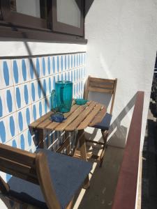 a wooden table and two chairs on a balcony at SantOporto Baixa in Porto