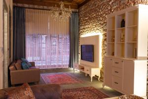 a living room with a couch and a tv in a room at Verula City Luxury Villa in Trabzon