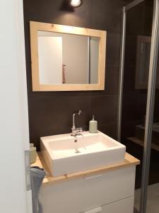 a bathroom with a white sink and a mirror at CANOLS#32 in Valbella