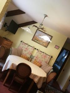 a room with a table and chairs and a lamp at Country House Dolomiti in Ortisei