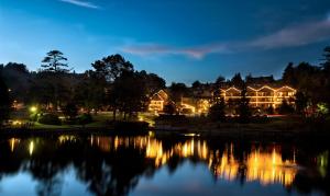 a view of a house with a lake at night at Chetola Resort at Blowing Rock (Lodge) in Blowing Rock