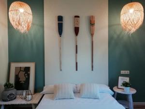 a room with a bed and some utensils on the wall at Vestal Suites Classic in Cambrils