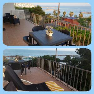 a balcony with a table and a view of the ocean at The Terrace of Puerto Banus Beach in Marbella