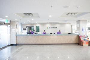 two people working at a counter in a store at Jeju Ilsung Beach Condo in Jeju