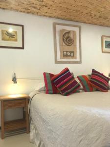 two beds in a room with a table and a picture at Hotel Pat'ta Hoiri in San Pedro de Atacama +81 photos