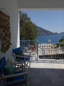 a balcony with chairs and a view of the water at "Gorgones" Mermaids Place in Kalymnos