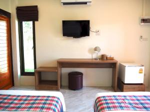 a room with a desk and a tv on the wall at Ina Boutique Home Nan in Nan +99 photos