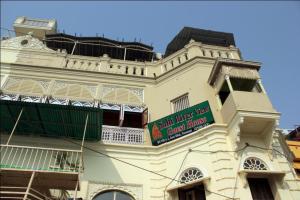 a building with a sign on the side of it at Sahi River View Guest house in Varanasi