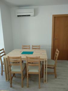 a wooden table and chairs in a room at Apartaments Can Fabul in Sant Carles de la Ràpita