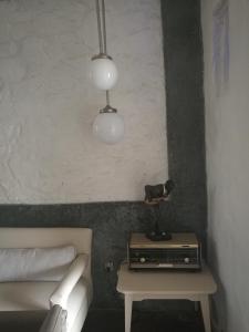 a bedroom with a bed and a table and two lights at Patio De La Luna in Asilah