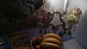 a bowl of fruit on a table next to a candle at Whatever Art B&B in Lisbon