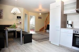 a kitchen and living room with a table and a dining room at Ferienwohnung „Kranich“ in Mirow