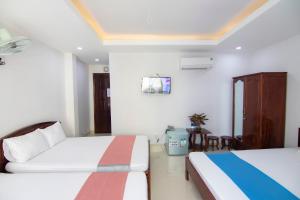 Postel nebo postele na pokoji v ubytování Thế Giang Hotel