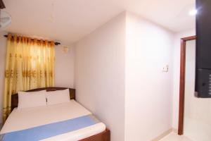 Postel nebo postele na pokoji v ubytování Thế Giang Hotel