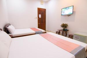 Postel nebo postele na pokoji v ubytování Thế Giang Hotel