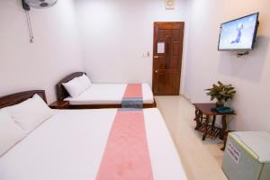 Postel nebo postele na pokoji v ubytování Thế Giang Hotel