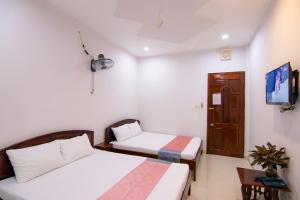 Postel nebo postele na pokoji v ubytování Thế Giang Hotel