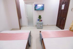Postel nebo postele na pokoji v ubytování Thế Giang Hotel