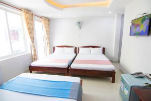 Postel nebo postele na pokoji v ubytování Thế Giang Hotel