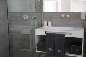 a bathroom with a sink and a shower at Carpe Diem Cadaqués in Cadaqués