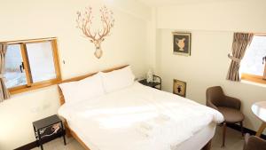 Una cama o camas en una habitación de Yo Ho 23 Homestay