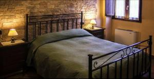 una camera da letto con un letto e due comodini con lampade di Agriturismo Rio Coverino a Borghetto
